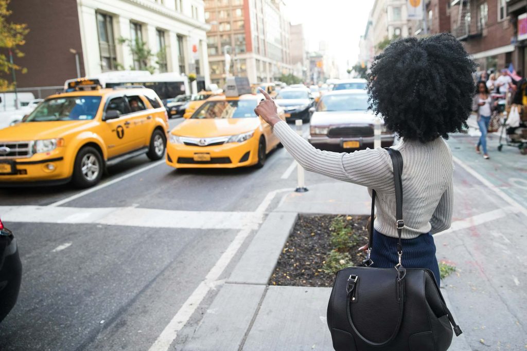 African american woman hailing a taxi cab in new york city.jpg