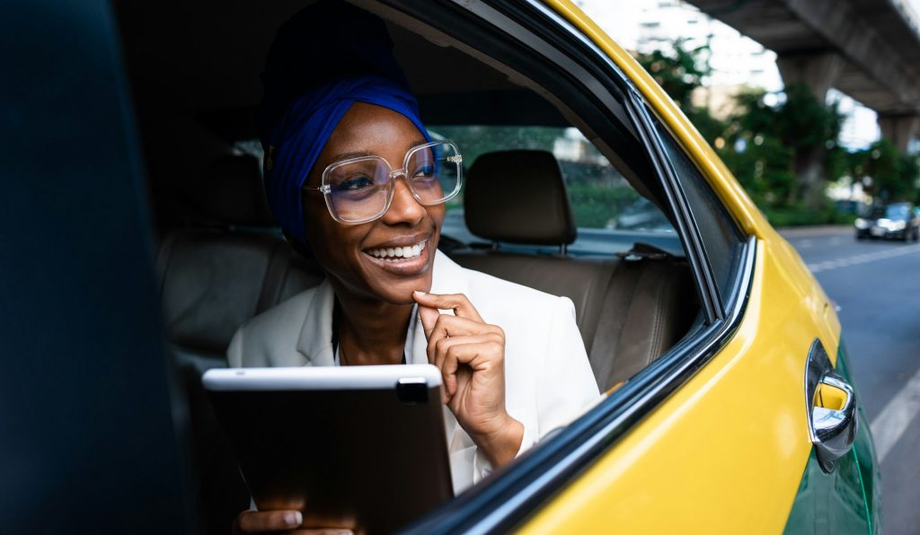 Beautiful business women driving at the airport leaving on for a working travel.jpg